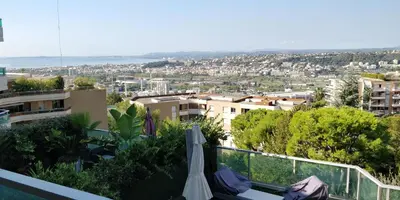 a view of a city from the balcony of a building at Chez Gaël, vue mer, piscine, 3chb in Nice