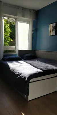 a large bed in a bedroom with a window at Chez Gaël, vue mer, piscine, 3chb in Nice