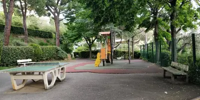 a park with a ping pong table and a playground at Chez Gaël, vue mer, piscine, 3chb in Nice