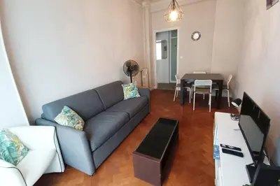 a living room with a couch and a table at Charming T2 apartment in Nice city center in Nice