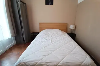 a bedroom with a bed with a white bedspread at Charming T2 apartment in Nice city center in Nice