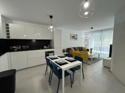 a kitchen and living room with a table and chairs at Fabron Hills By Avecoeur in Nice