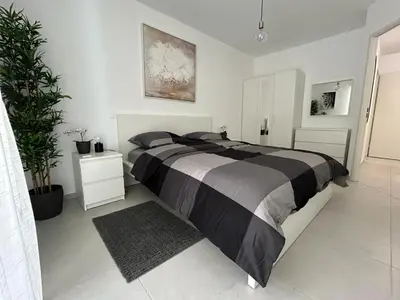 a bedroom with a large bed and a plant at Fabron Hills By Avecoeur in Nice