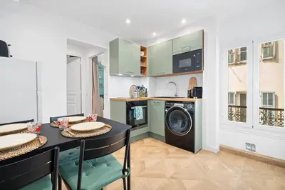 a kitchen with a table and a washing machine at Nice Renting - BARBERIS - Unique Getaway 2-Room with Rooftop Terrace in Nice