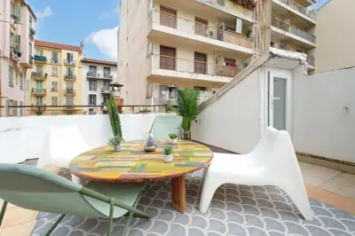 a patio with a table and chairs on a balcony at Nice Renting - BARBERIS - Unique Getaway 2-Room with Rooftop Terrace in Nice