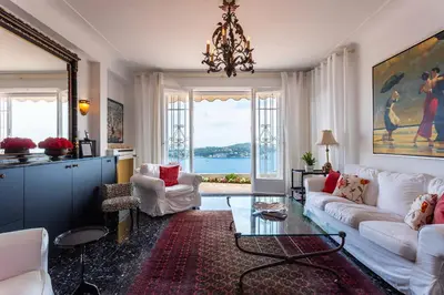 a living room with a white couch and a chandelier at ROMANTIC VILLA VI4412 By Riviera Holiday Homes in Villefranche-sur-Mer