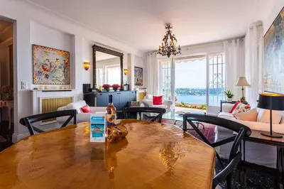 a living room with a wooden table and chairs at ROMANTIC VILLA VI4412 By Riviera Holiday Homes in Villefranche-sur-Mer