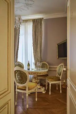 a room with a table and chairs and a window at Maison des Barons in Nice