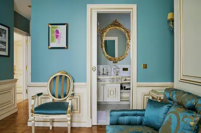 a living room with a couch and a mirror at Maison des Barons in Nice