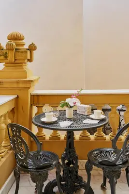 a table with two chairs and two cups on it at Maison des Barons in Nice
