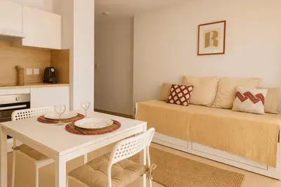 a living room with a table and a couch at Charming 23 m studio near the sea in Nice