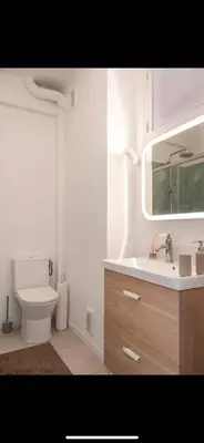 a bathroom with a sink and a toilet and a mirror at Studio de luxe au cœur de Nice in Nice