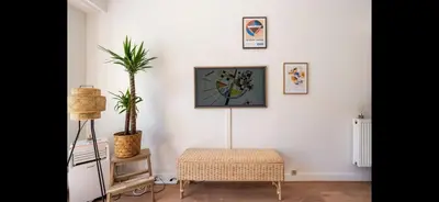 a living room with a plant on the wall and a table at Studio de luxe au cœur de Nice in Nice