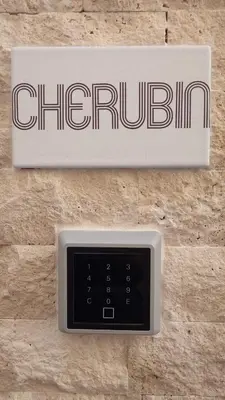 a sign on a wall with a clock on it at Club Inn Appartement in Nice