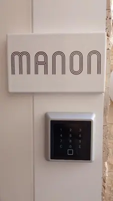 a lightswitch on a wall with a sign on it at Club Inn Appartement in Nice