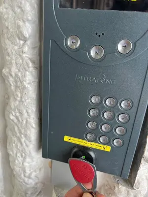 a person holding a pair of scissors in front of a safe at Palm Leaf Studio Nice in Nice