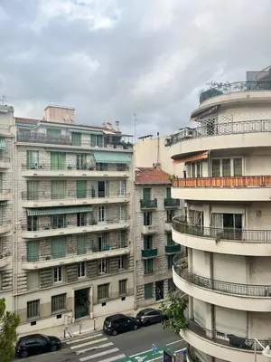 a group of buildings with cars parked in front of them at Palm Leaf Studio Nice in Nice