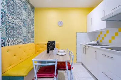 a small kitchen with a table and chairs and a couch at 2P hyper-centre Nice in Nice