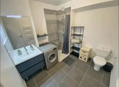 a bathroom with a sink and a washing machine at Studio cosy près du port in Nice