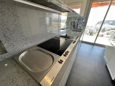a kitchen with a sink and a counter top at ApartHotel Riviera - TERRASSE DES AGAVES - Amazing Sea View Nice Côte d'Azur in Nice