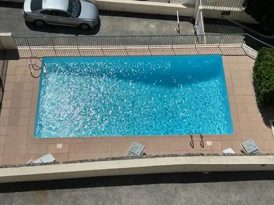 an overhead view of a swimming pool with a car at ApartHotel Riviera - TERRASSE DES AGAVES - Amazing Sea View Nice Côte d'Azur in Nice