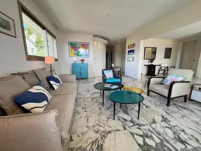 a living room with a couch and two tables at ApartHotel Riviera - TERRASSE DES AGAVES - Amazing Sea View Nice Côte d'Azur in Nice