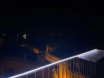 a light on the side of a building at night at The Seaside Serenity -NEW AC equipped - Calm with Bay View - Heart of Villefranche in Villefranche-sur-Mer