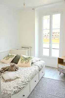 a white bedroom with a large bed with a window at The Seaside Serenity -NEW AC equipped - Calm with Bay View - Heart of Villefranche in Villefranche-sur-Mer