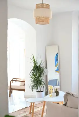 a living room with a table and a potted plant at The Seaside Serenity -NEW AC equipped - Calm with Bay View - Heart of Villefranche in Villefranche-sur-Mer