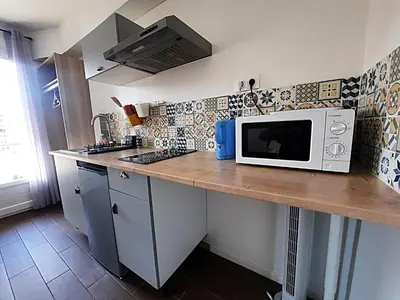 a kitchen with a counter with a microwave on it at La chambre 2, Climatisée AC, Calme, Cuisine privée in Nice