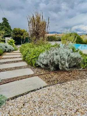 a garden with a stone pathway and plants at DOMAINE LOU BEL AZUR - Harmonie in Saint-Laurent-du-Var
