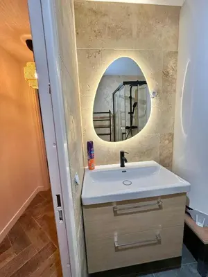 a bathroom with a sink and a mirror at Modern & Cosy 3 Bedrooms train tramway in Nice
