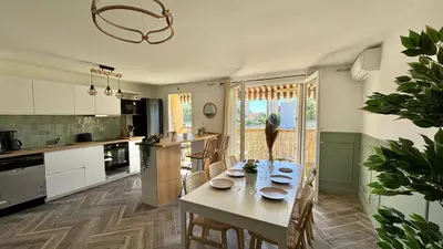 a kitchen with a table and chairs in a room at Modern & Cosy 3 Bedrooms train tramway in Nice