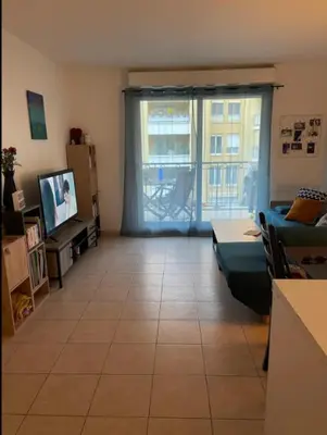 a living room with a couch and a tv at Happy place in Nice