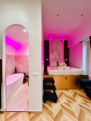a room with two beds and pink lighting at Intimate Escape - Seaside - Spa Bath - WIFI - AC in Nice