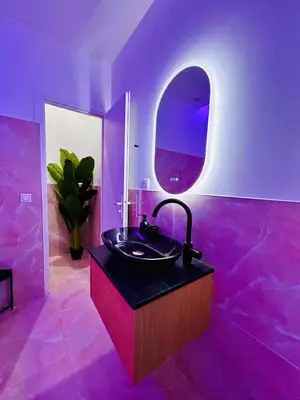 a purple bathroom with a sink and a mirror at Intimate Escape - Seaside - Spa Bath - WIFI - AC in Nice