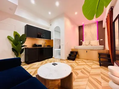 a living room with a couch and a table at Intimate Escape - Seaside - Spa Bath - WIFI - AC in Nice