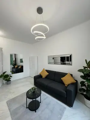 a living room with a black couch and a table at Newly refurbished studio in Nice
