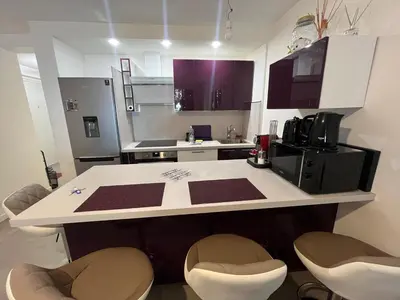 a kitchen with a white counter top in a room at Port Lympia - Grand 2 Pièces Confort in Nice
