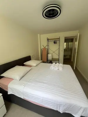 a bedroom with a large bed with towels on it at Port Lympia - Grand 2 Pièces Confort in Nice