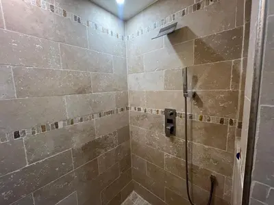 a bathroom with a shower with a glass door at Port Lympia - Grand 2 Pièces Confort in Nice