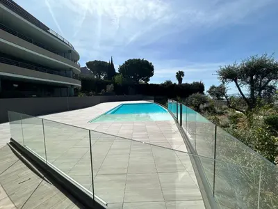 a glass walkway leading to a swimming pool at L'Oasis Maritime By Avecoeur in Nice