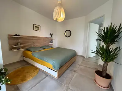 a bedroom with a bed and a potted plant at L'Oasis Maritime By Avecoeur in Nice