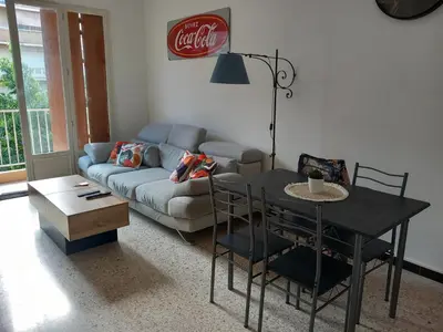 a living room with a couch and a table at Appartement cosy Nice in Nice