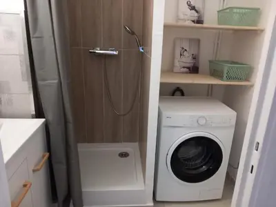 a bathroom with a washing machine and a washer at Appartement cosy Nice in Nice