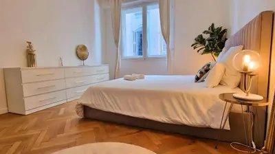a bedroom with a bed and a dresser and a window at Jazzy et Spacieux Appartement Prom des Anglais in Nice