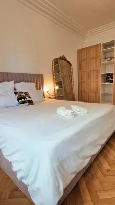 a large white bed with two towels on it at Jazzy et Spacieux Appartement Prom des Anglais in Nice