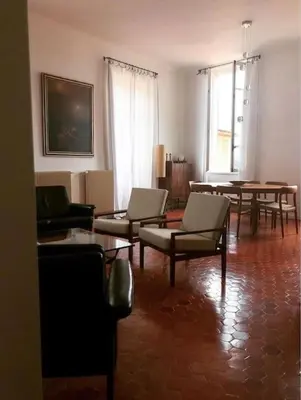 a living room with chairs and a table in it at Blue House in Villefranche-sur-Mer
