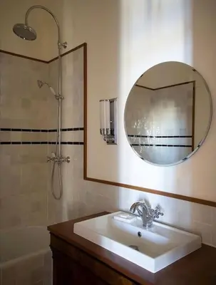 a bathroom with a sink and a mirror and a tub at Blue House in Villefranche-sur-Mer