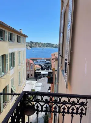 a view of a city from a balcony of a building at Blue House in Villefranche-sur-Mer